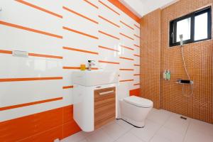 a bathroom with a white toilet and a sink at Discovery B&B in Linbian +51 photos