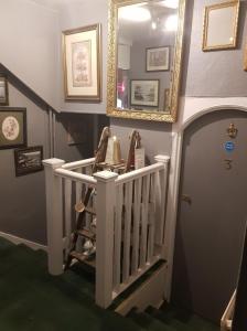 a stairway with a mirror and a stair case at The Harbour Moon in Looe