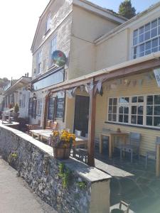 a building with a picnic table in front of it at The Harbour Moon in Looe