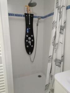 a bathroom with a black board on the wall at Joli T2 proche plages in Bidart