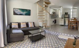ein Wohnzimmer mit Couch und Küche in der Unterkunft El Cortijo Bungalow - Pool - Free Parking in Playa de las Americas