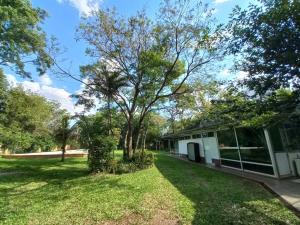 a house with a yard with a building at Parana Riverside Guest House - Posadas in Posadas