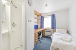 a bedroom with a bed and a desk and a sink at Vibrant Ensuite Rooms, HATFIELD - SK in Hatfield