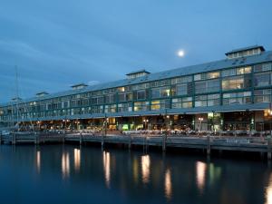 a large building next to a body of water at Ovolo Woolloomooloo in Sydney