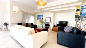 uma sala de estar com dois sofás e uma televisão em Villa Clara Premium by Sunny Deluxe em Albufeira