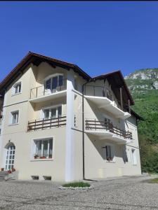 a white building with balconies on the side of it at Casa Astoria in Băile Herculane