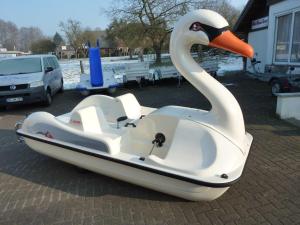a swan boat parked in a parking lot at Seeblick in Mühbrook