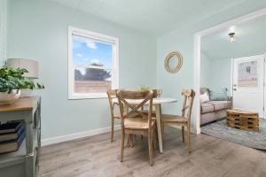a dining room with a table and chairs at Coral Cottage Unit 2 in Rockaway Beach +11 photos