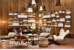 a room with chairs and tables and a wall of pictures at Ecrin Blanc Resort Courchevel - Aquapark in Courchevel