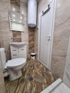 a bathroom with a toilet and a sink at Luxury two bedroom apartment with free parking in Botevgrad