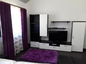 a living room with a tv and a bed at Casa da Pedra in Horta