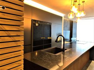 a kitchen with a sink and a black counter top at Luxury Aparment 5 room 2 minutes from the beach in Bat Yam