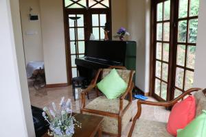 a living room with a couch and a piano at Araliya Home Stay in Kandy