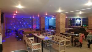 a restaurant with tables and chairs in a room at Penzion Malina in Hronská Dúbrava