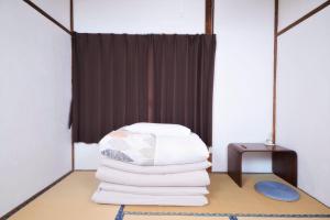 Postel nebo postele na pokoji v ubytování Nikko Guesthouse Sumica