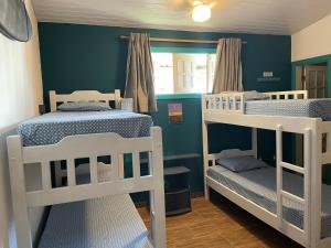 two bunk beds in a room with blue walls at Bada Hostel & Kite School in Cumbuco