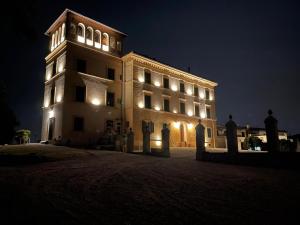 a large building with lights on it at night at Villa Conti in Fauglia