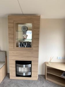 a living room with a fireplace in a room at Lovely 4 berth caravan on 7 Lakes Country Park at Crowle North Lincolshire in Crowle