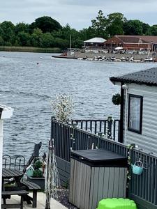 a house next to a body of water at Lovely 4 berth caravan on 7 Lakes Country Park at Crowle North Lincolshire in Crowle