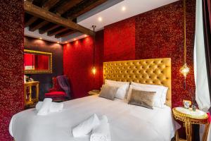 a bedroom with a large bed with red walls at Ca' Maria Callas in Venice