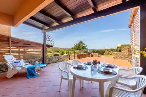 スティンティーノにあるSARDINIA RE - Villino Punta Negraのパティオの白いテーブルと椅子