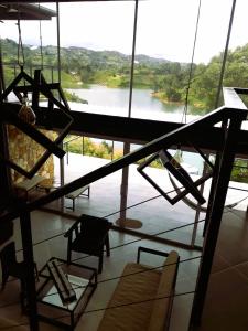 a room with a large window with a view of a river at El Espume de San Juan by JR in Guatapé