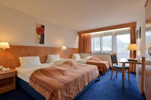 Postel nebo postele na pokoji v ubytování Tennenwirt Hotel