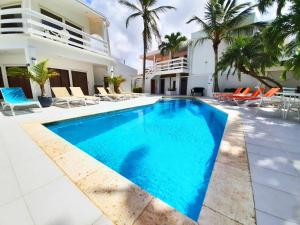 a swimming pool in front of a house at Bubali Residence in Palm-Eagle Beach