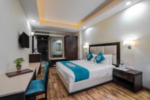a hotel room with a large bed and a desk at Snow Valley Resorts Shimla in Shimla