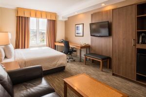 a hotel room with a bed and a desk at Future Inns Halifax Hotel & Conference Centre in Halifax
