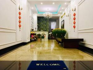 a lobby of a hotel with a welcome sign on the floor at Queen Hotel in Quy Nhon