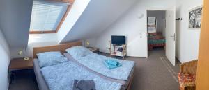 ein kleines Schlafzimmer mit 2 Betten im Dachgeschoss in der Unterkunft Sterntaler (Landhaus Immenbarg) in Rostock