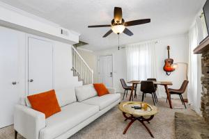 a living room with a white couch and a table at Charming East Escape in Nashville