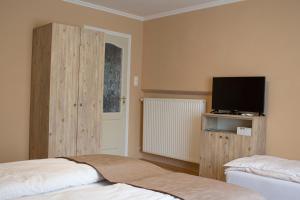 Posteľ alebo postele v izbe v ubytovaní Ilona Apartman