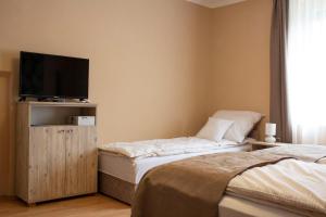 Posteľ alebo postele v izbe v ubytovaní Ilona Apartman