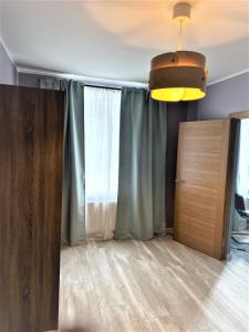 a room with a curtain and a sliding door at Classic and calm city center in Rīga