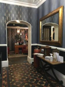 a dressing room with a mirror and a table at Castle Lodge Wilton in Ross on Wye