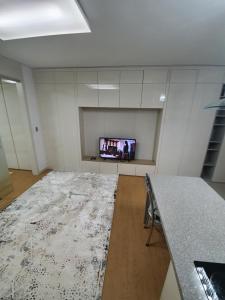 an empty room with a table and a tv at апартаменты в ЖК Хайвил in Astana