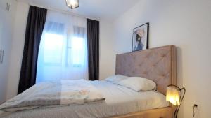 a bedroom with a bed and a window at Comfy apartment - Sea View in Becici