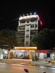 a tall building with a sign on it at night at Anh Anh Guest House in Ha Giang