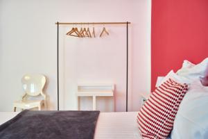 a bedroom with a white bed and a white dresser at Al Cavour 34 in Trento