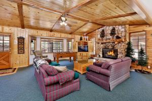 a living room with two couches and a fireplace at Retreat to Fox Farm-1662 by Big Bear Vacations in Big Bear Lake