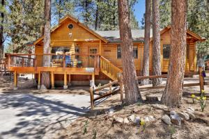 a log cabin in the woods with a large deck at Retreat to Fox Farm-1662 by Big Bear Vacations in Big Bear Lake