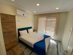 Tempat tidur dalam kamar di Garden Butik & Apart Hotel Akbük