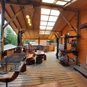 a large wooden deck with furniture on it at Pillang Likan tinas calientes, el poder del Volcan in Puerto Varas