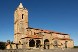 an old church with a tall tower with a clock at El Nido in Ajo