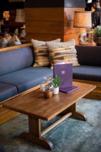 a purple laptop on a wooden table in a living room at Freehand Los Angeles in Los Angeles