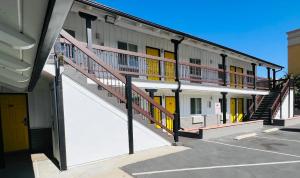 a building with a staircase in a parking lot at Escondido Inn in Escondido