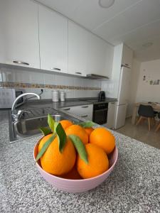 a bowl of oranges on a counter in a kitchen at Casa Queralt in Les Cases d'Alcanar