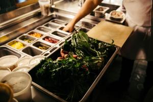 a person preparing food in a restaurant kitchen at Freehand Los Angeles in Los Angeles